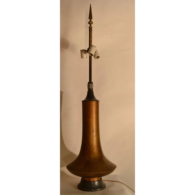 Copper patinated vessel form body on painted wood plinth base, three light cluster, and original spire form finial. Shade...
