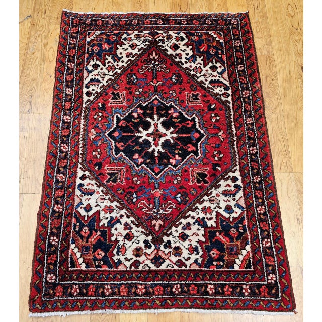 "A rare find in a near square format, this mid-20th century Persian Heriz area rug is a striking example of traditional...