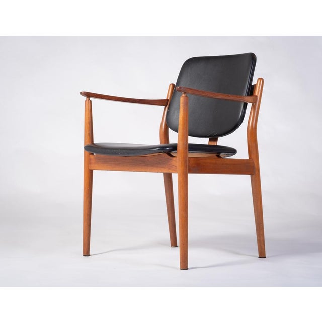 This chair was designed in the 1960s by Arne Vodder for Sibast furniture. The frame of the armchair is made of solid teak...