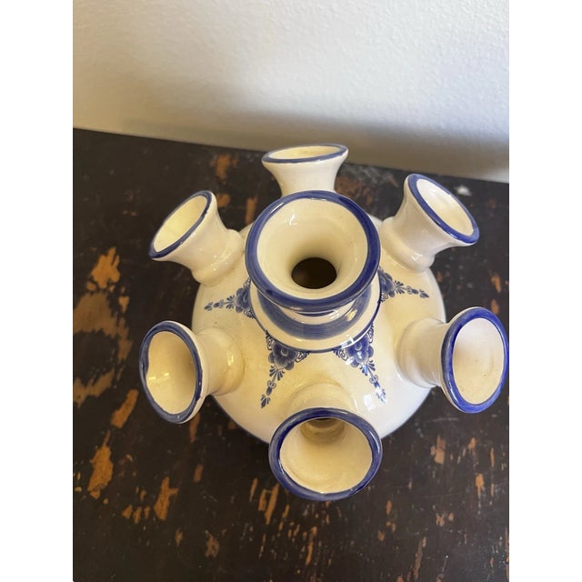 Celebrate the timeless beauty of Dutch craftsmanship with this **Vintage Delft Blue Delfino 7-Arm Tulip Vase**, proudly...