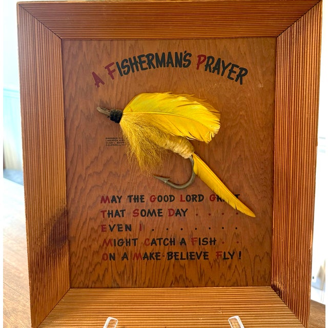The most striking feature of this decor piece is the large vibrant, yellow fishing fly. It’s exaggerated size and vivid...