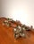 Elegant vintage wall lamp featuring two sculptural floral light points connected by a flowing curved arm. Crafted in...