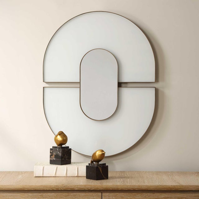 The Encase Oval Mirror Features A Striking Design With Two Semicircular Sections Of White Glass, Each Encased In A...