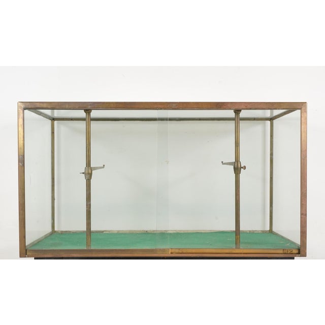 Antique display case manufactured in France during the late 19th to early 20th century. It features a brass slim frame,...