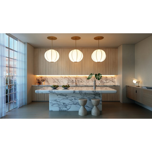 As the name suggests, Jupiter is large in scale and draws the eye upward. An aged brass metal frame is wrapped in white...