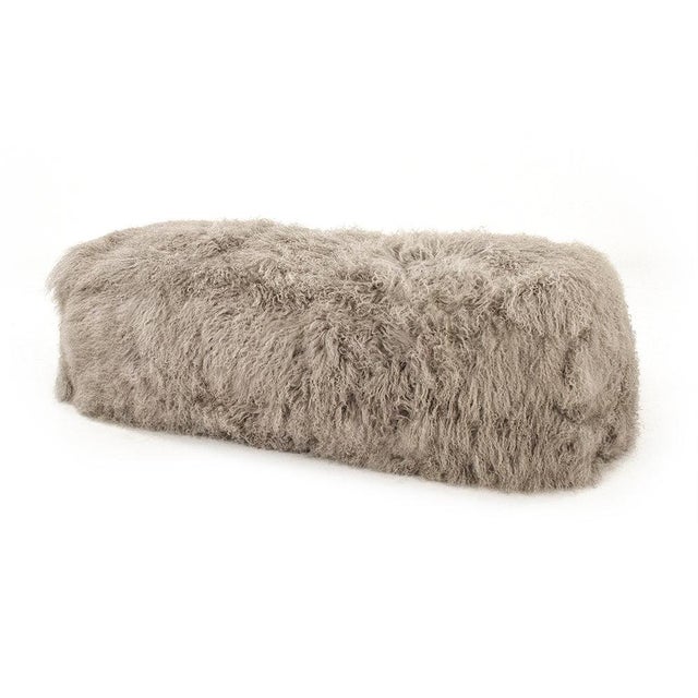 The Tibetan Lamb Fur Bench from Zentique is a luxurious bench with a removable light grey Tibetan lamb fur cover on a...