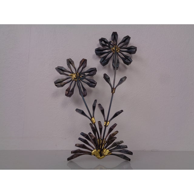 Brutalist wall sculpture made of cast iron and gold applications from the 1960s.