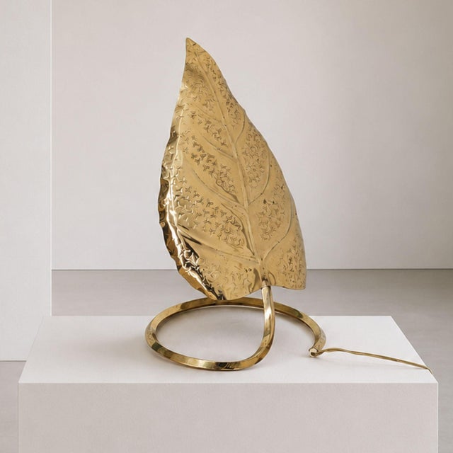 Elegant Italian table lamp from the 1970s, crafted in brass and designed in the decorative style often associated with...