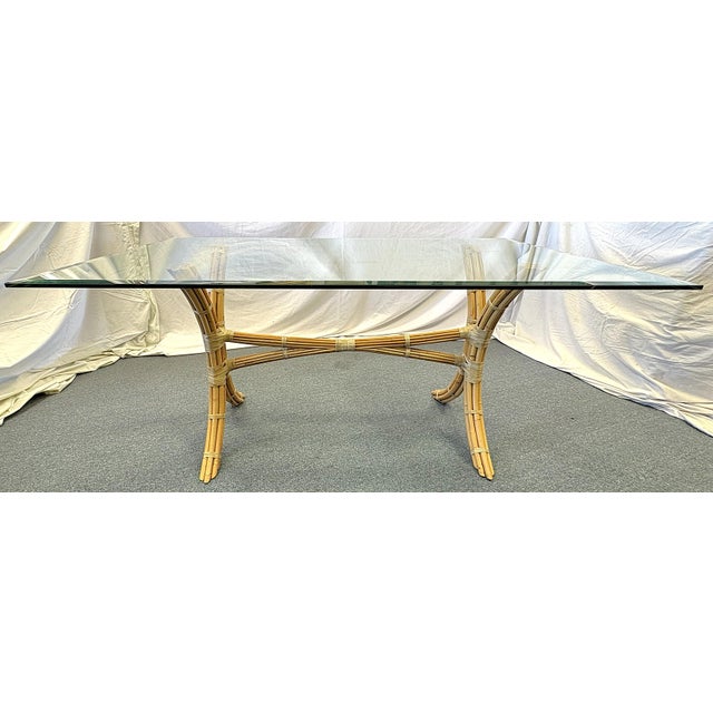 A timeless vintage McGuire Style dining table from the mid 20th century. The base is made of curved bamboo wrapped in...