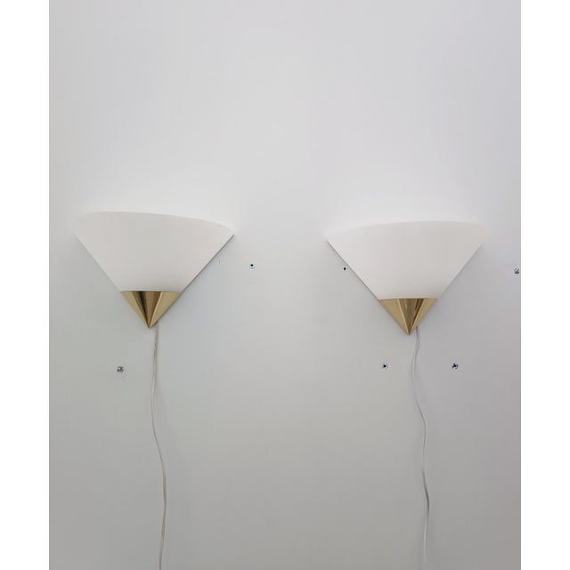 Magnificent pair of wall sconces, model 3671, by Glashütte Limburg. Germany, 1970s. White lacquered metal frame with brass...