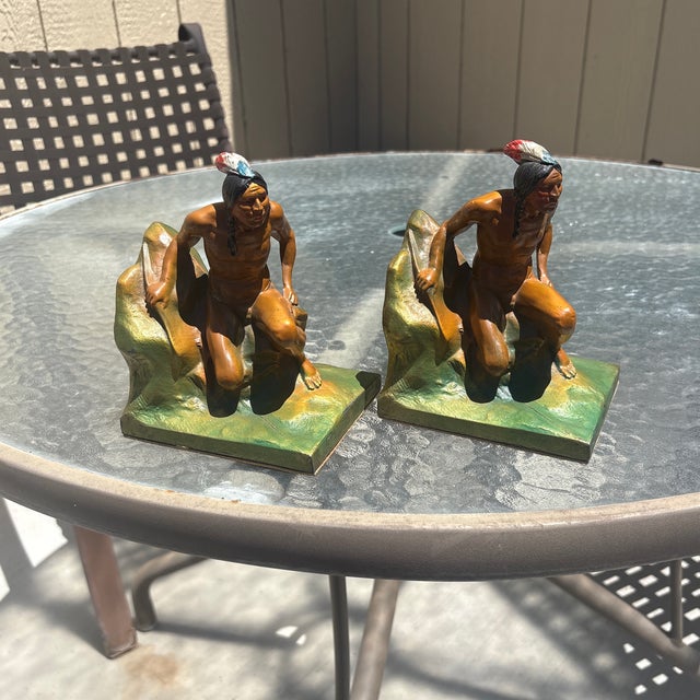 Striking pair of early 20th-century Native American Indian figural bookends, beautifully modeled and hand-painted in rich...