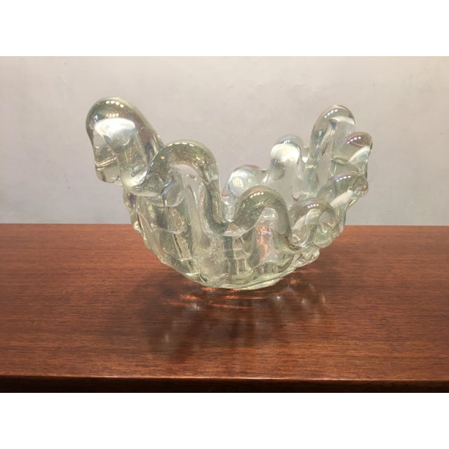 The heavy shell-shaped glass bowl is made of iridescent, mouth-blown Murano Glass with rib decoration. Therefore, the name...