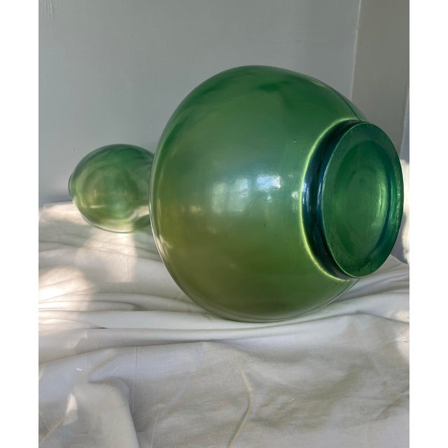 This sculptural Japanese Art Deco–inspired glass form features a luminous green iridescent finish and an elegant bulbous...