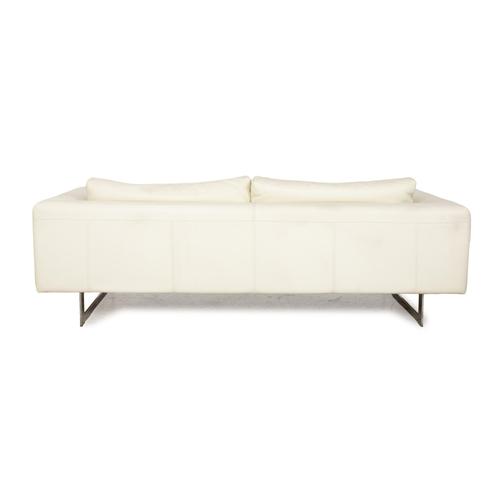 The sofa from La Nuova Casa is covered in cream-white leather and stands on narrow metal runners. It is characterized by...