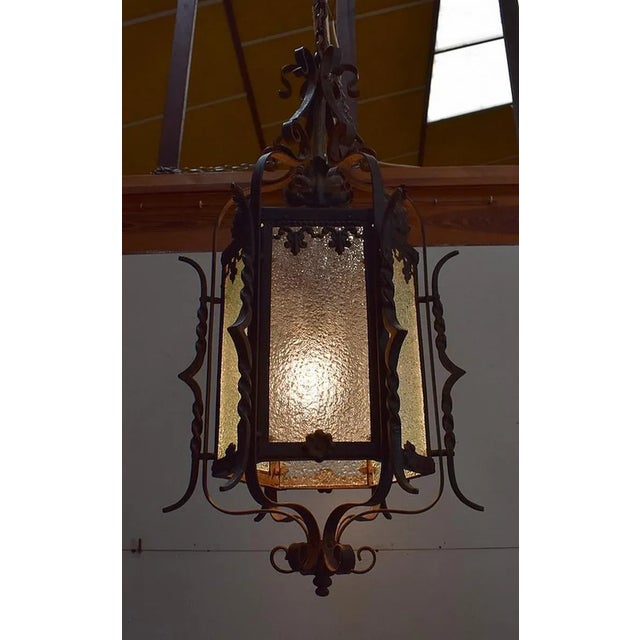 Hexagonal lantern with natural wrought iron frame. Its six rectangular faces are composed of Granite Glass on the outside,...
