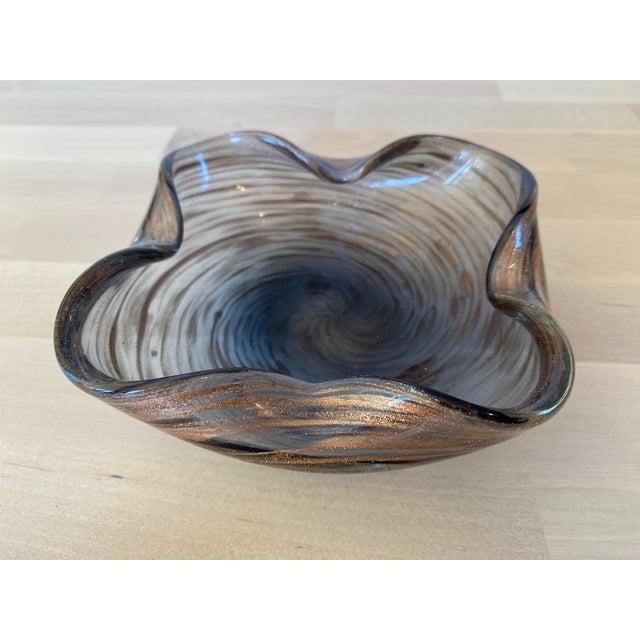 A stunning floriform midcentury Murano glass bowl with a dynamic swirling design in copper fleck.