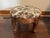 Charming vintage footstool featuring beautifully carved solid wood detailing and elegant cabriole-style legs. The...