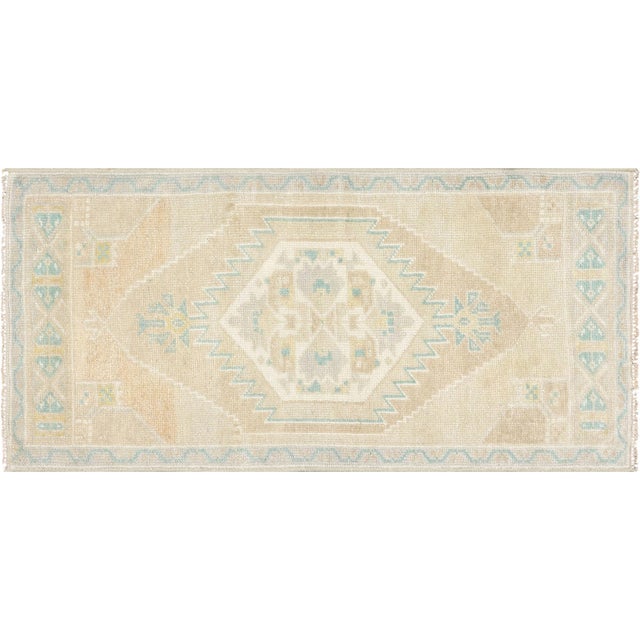 This Vintage Turkish Oushak Yastic rug measures 1'7" by 3'3", combining timeless design and durable materials to make a...