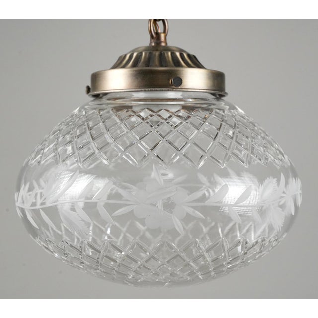Traditional style pendant light made of an etched glass globe and a brass finish steel chain fitter. This requires one...