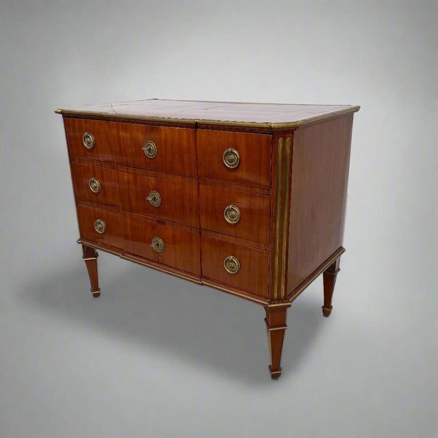 A fine Neoclassical chest of drawers from Germany, circa 1800. The entire chest is sheathed in mahogany having an...