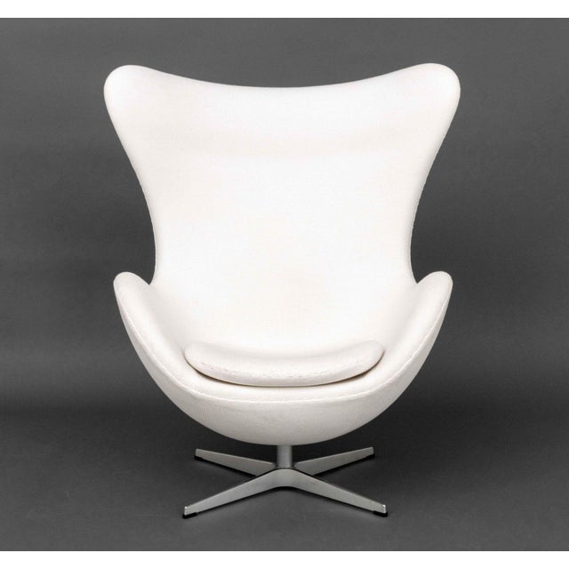 Fritz Hansen White Upholstered Egg Chair, label to seat. 31" H x 34" W x 27" D; seat: 14.5" H. Provenance: From a One...