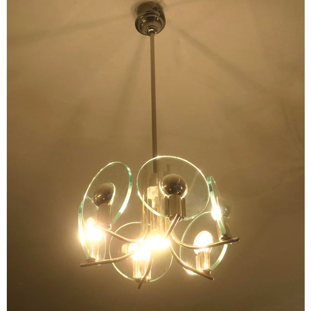 Chandelier on a silver-plated frame with 6 cut glass discs, Italy 1960s. Up to 250V (Europe/UK Standard).The wiring of...