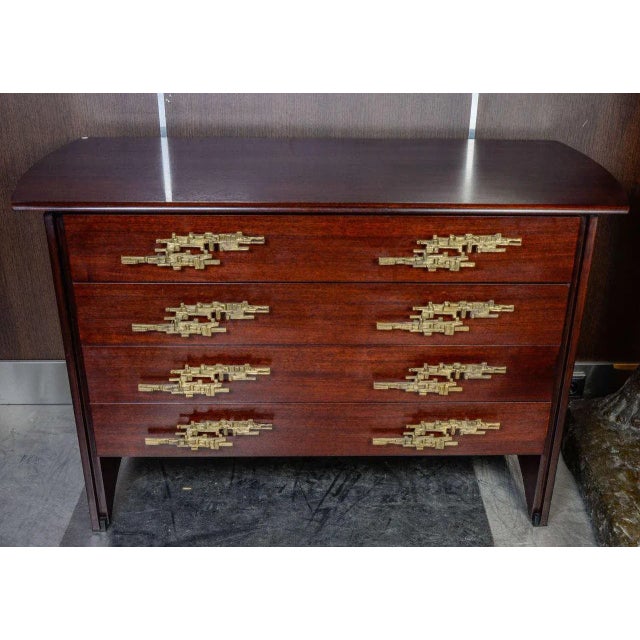 This rosewood chest of drawers in the style of Angelo Brotto was produced in Italy in the 1960s.