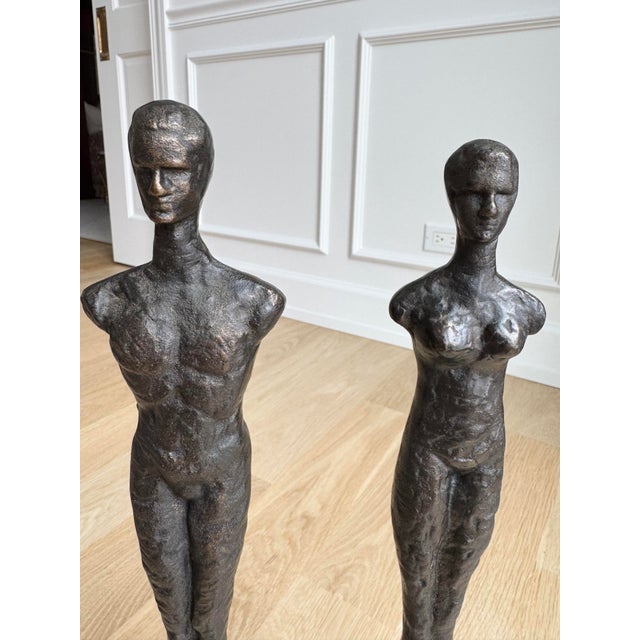 A rare and highly sought-after discontinued pair of figural sculptures by Global Views, featuring elongated male and...