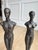 A rare and highly sought-after discontinued pair of figural sculptures by Global Views, featuring elongated male and...