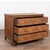 Late 18th-century French oak chest of three drawers featuring decorative paneled drawer fronts and curved canted sides...