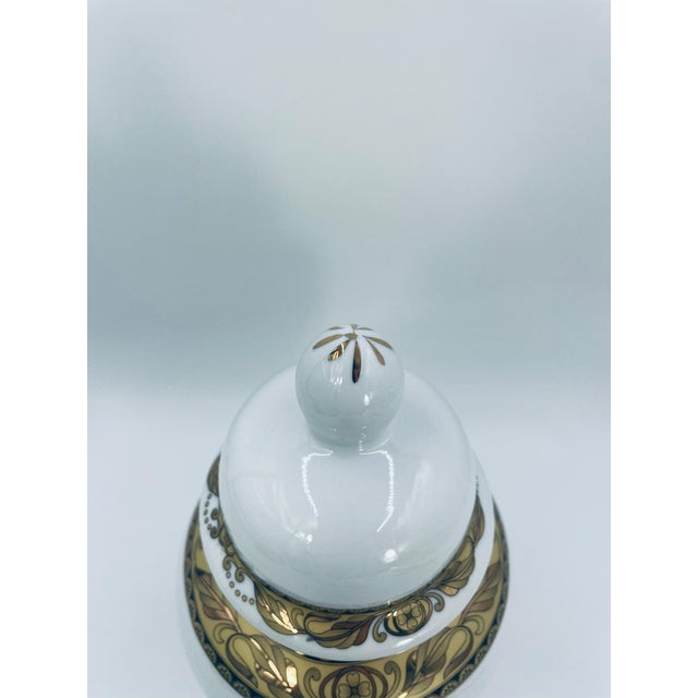Decorative vintage-style vase with lid, crafted from high-quality white porcelain. This handmade amphora-shaped vase...