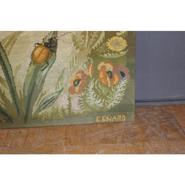 Art Nouveau style tapestry decorated with flowers and insects, including a ladybug and dragonfly. Signed lower right C....