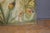 Art Nouveau style tapestry decorated with flowers and insects, including a ladybug and dragonfly. Signed lower right C....