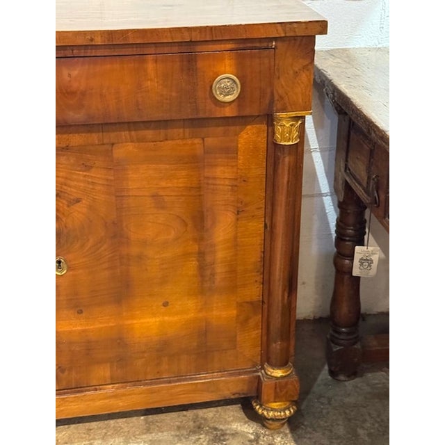 The 19th c. French Empire Walnut Buffet is a luxurious and elegant piece of furniture made from high-quality walnut. This...