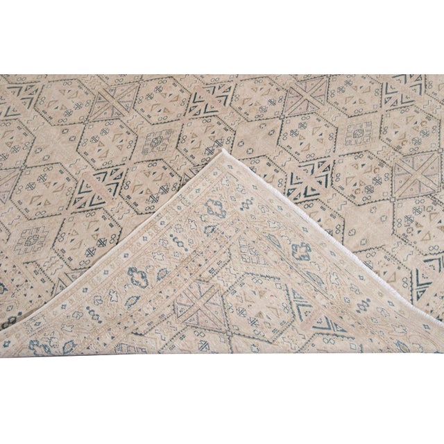 Beautiful vintage Turkish hand-knotted wool rug with a beige field. This Turkish rug has navy-blue, pink, and brown...