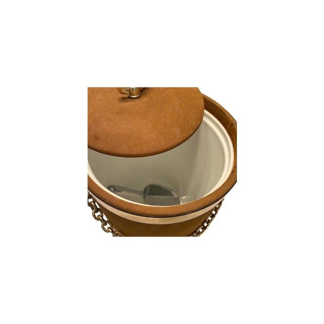 A Mid mid-century modern gold velvet ice bucket is a stylish and functional piece of barware that adds a touch of elegance...