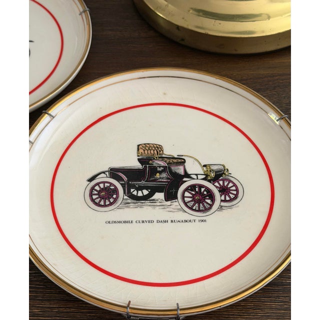Vintage pair of Hyalyn porcelain decorative wall plates featuring the 1906 Ford Model N and the 1901 Oldsmobile Curved...