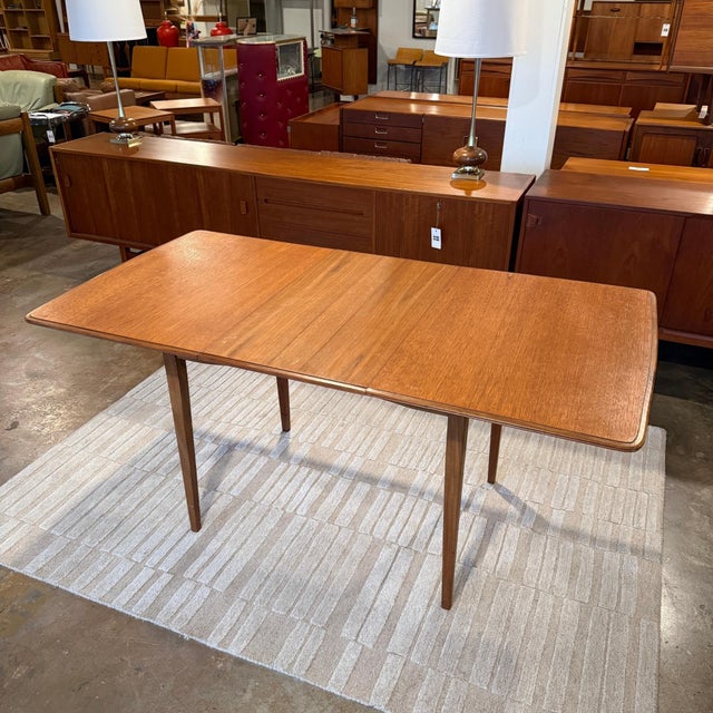 Vintage mid-century Danish modern extending dining table with insertable leaf and hidden leaf storage slot. Great vintage...