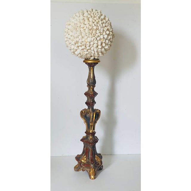 Gorgeous 12” sea shells encrusted oval encrusted globe on an Italian polychrome wood gold leaf pricket stand.