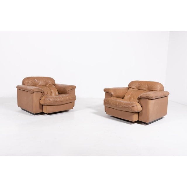 Pair of De Sede DS-101 patinated brown leather armchairs with pouf. Excellent comfort with an extendable seat for lounge...