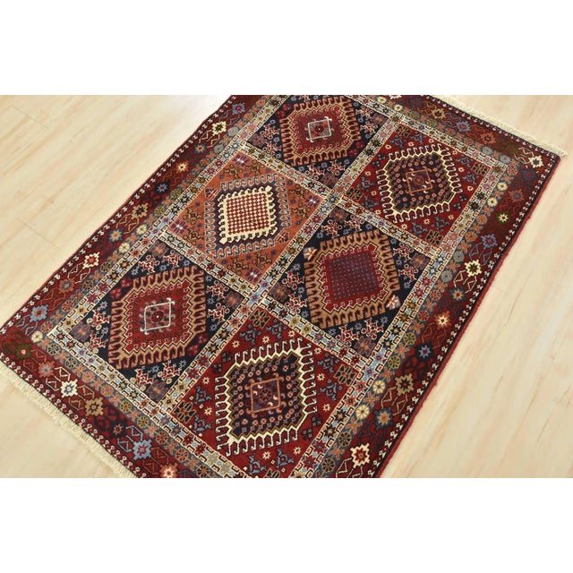 An authentic vintage tribal Yalameh rug hand-knotted with fine wool and natural dyes. This nomadic oriental rug features...