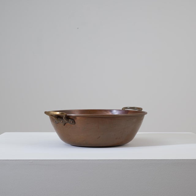 This 19th Century Belgian copper pot is a finely crafted example of utilitarian European metalwork, valued today for both...