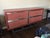 Custom credenza with a clear Lucite base and a burnt red lacquer wood frame (satin finish). Drawer fronts are covered in...