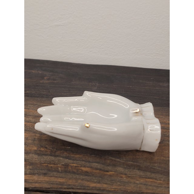 Add a touch of vintage charm to your vanity or bedside table with this delicate porcelain trinket dish. Crafted in the...