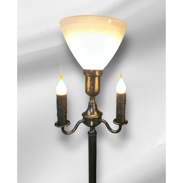 This floor lamp is a classic example of the mid-century modern style! It features an upper socket that supports a conical...