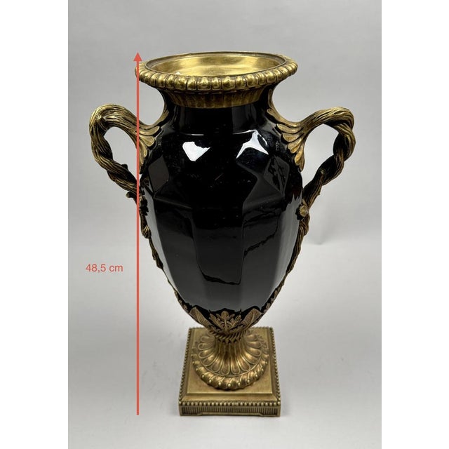 Large black ceramic vase, neoclassical style with gilt bronze handles, late 19th century. An elegant baluster-shaped vase...