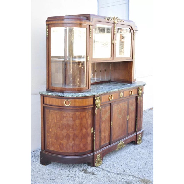 Antique French Louis XV Style Marble Top Bowed Glass Bronze Ormolu Sideboard. Item features an upper bowed glass curio...