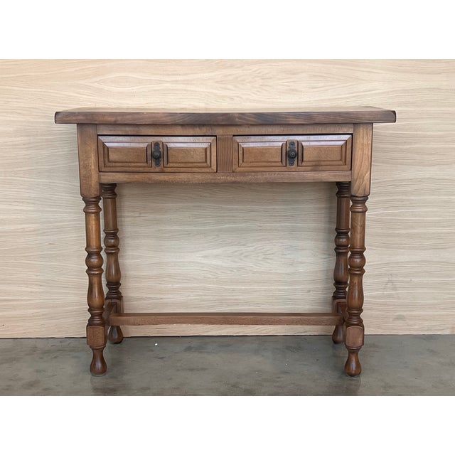 Early 20th century carved Spanish console with two drawers. This table with character is of rare narrow depth. It is...