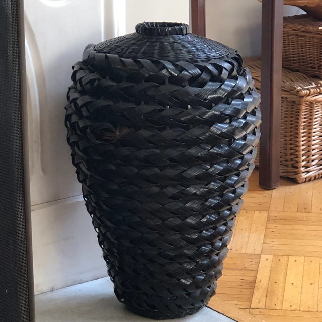 Offering a tall urn-style rattan floor vase with stunning black lacquer finish. The wide and intricately handwoven fibers...