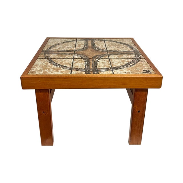 A tile top coffee or side table by Trioh. Made in Denmark, this table features tiles with a design that form a large...
